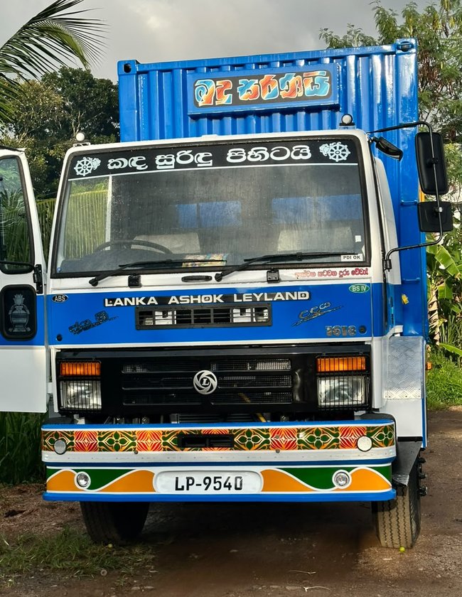 Front view of an Udaya Transport 20 ft container truck